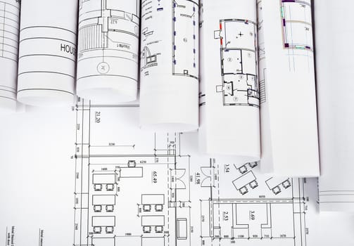 Blueprints and rolls of blueprints, top view. Building concept
