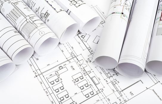 Blueprints and rolls of blueprints, top view. Building concept