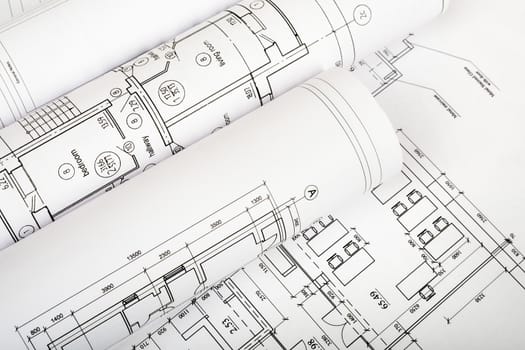 Rolls of blueprints, top view. Building concept