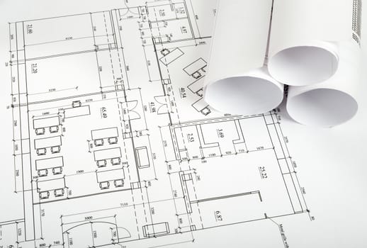 Blueprints and rolls of blueprints, side view. Building concept