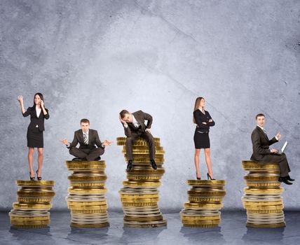 Business people doing different things on coins on grey wall background, business concept