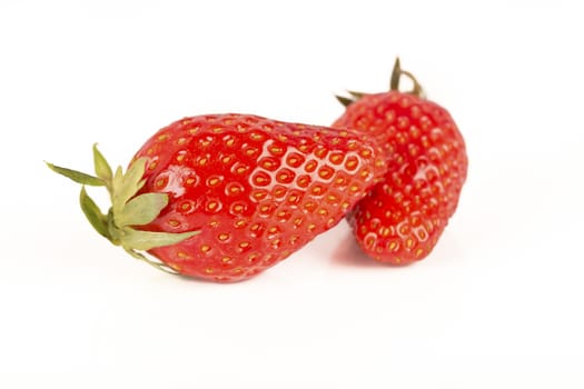 Two strawberries close up on white background France