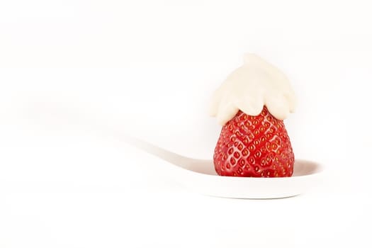 strawberry with cream vanilia in white spoon white background France