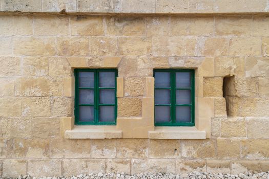 Detailed view of Valletta city in Malta island with limestone buildings from medieval times, on cloudy sky background.