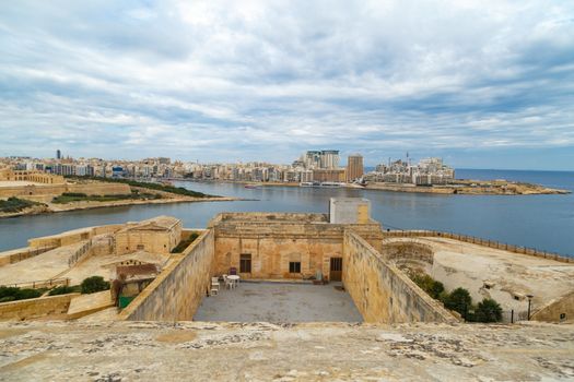 VALLETTA, MALTA - OCTOBER 30, 2015 : General view of Valletta, Malta island with seascape, port and historical limestone buildings from medieval times.