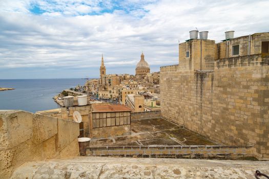 VALLETTA, MALTA - OCTOBER 30, 2015 : General view of Valletta, Malta island with seascape, port and historical limestone buildings from medieval times.