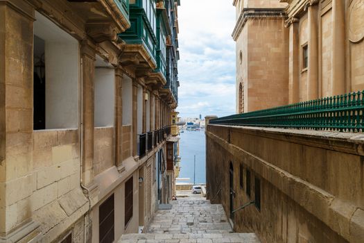 Detailed view of Valletta city in Malta island with limestone buildings from medieval times, on cloudy sky background.