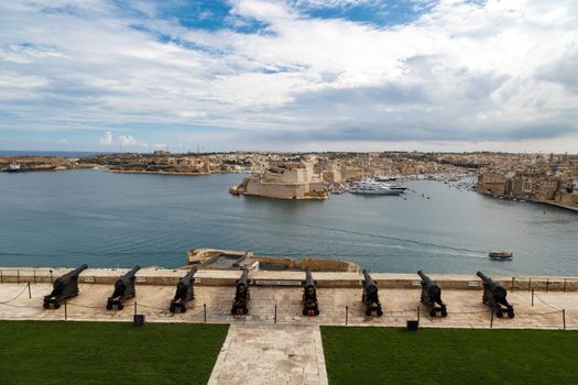 VALLETTA, MALTA - OCTOBER 30, 2015 : View of the gardens of Lascaris War Rooms in Valletta, Malta, with seascape on cloudy blue sky background.