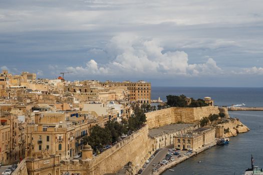 VALLETTA, MALTA - OCTOBER 30, 2015 : General view of Valletta, Malta island with seascape, port and historical limestone buildings from medieval times.