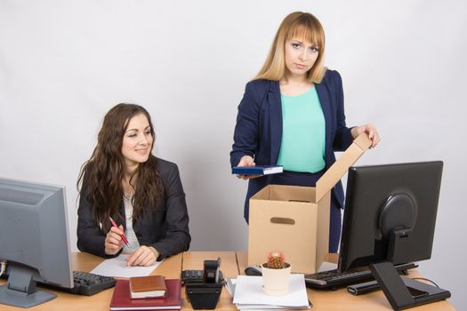 Office staff member with a smile watching charges fired colleagues