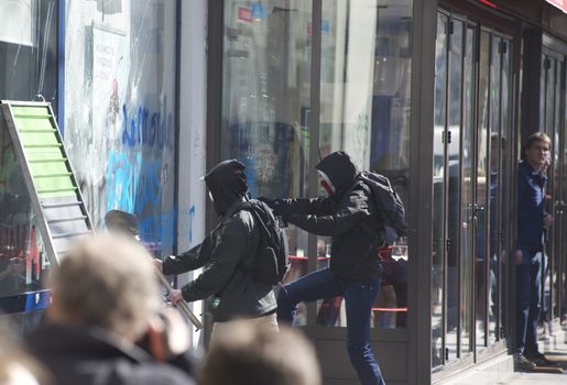 FRANCE, Paris: Troublemakers attack a shop window during a student demonstration against French government Labour Law reform in Paris on March 17, 2016.