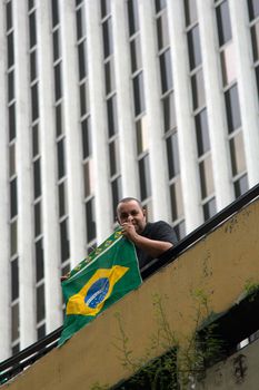 Paulo Brazil March 13, 2016: One unidentified man with brazilian flag in the biggest protest against federal government corruption in Sao Paulo.