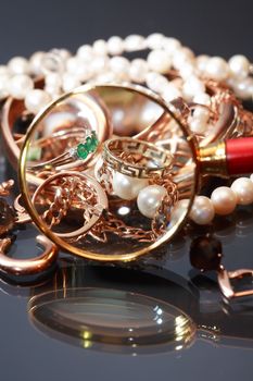 Set of various jewelry adornments through the magnifying glass