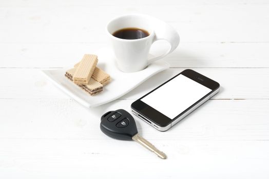 coffee cup with wafer,phone,car key on white wood background