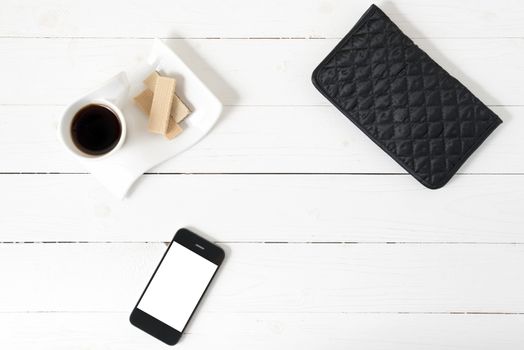 coffee cup with wafer,phone,wallet on white wood background