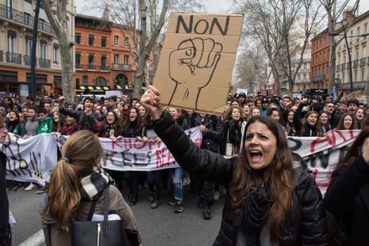 FRANCE, Paris: A young woman raises his fist in front of a sign reading No! as thousands of high school students demonstrate during a protest march opposing the government's labour reforms on March 17, 2016 in Toulouse.