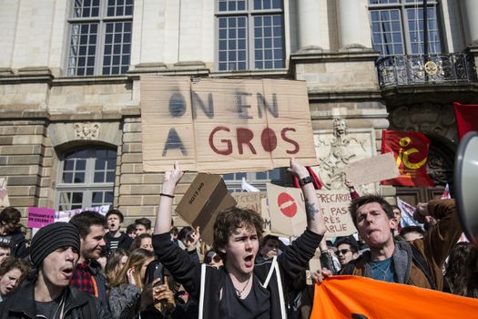 FRANCE, Paris: High school students and youths demonstrate in front of Rennes' town hall, western France,  during a protest march opposing the government's labour reforms on March 17, 2016.The contested reform is designed to inject more flexibility into the labour market by dropping key measures that would have benefited smaller companies. In a significant change from the original text, French Prime minister said on Monday that small and medium-sized companies would not be able to unilaterally introduce flexible work practices into their working week.