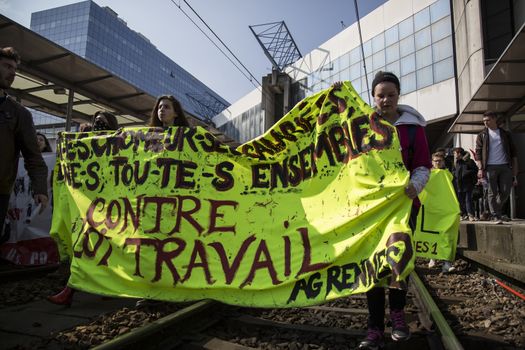 FRANCE, Paris: High school students and youths demonstrate on the rail tracks of Rennes' railway station, western France,  during a protest march opposing the government's labour reforms on March 17, 2016. The contested reform is designed to inject more flexibility into the labour market by dropping key measures that would have benefited smaller companies. In a significant change from the original text, French Prime minister said on Monday that small and medium-sized companies would not be able to unilaterally introduce flexible work practices into their working week.
