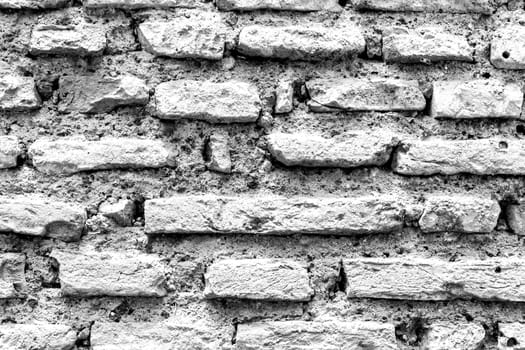 horizontal view of a rustic black and white bricked wall