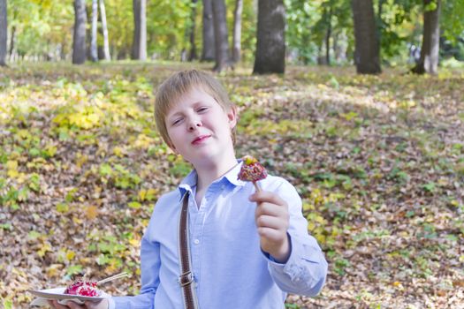 Photo of boy eating dessert with appetite