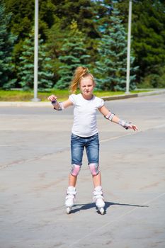 Photo of cute girl on roller skates in summer