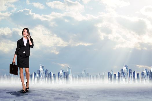 Businesswoman talking on phone on cityscape background, business concept