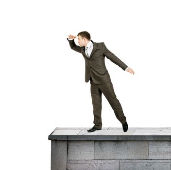 Businessman standing on roof isolated on white background, danger concept