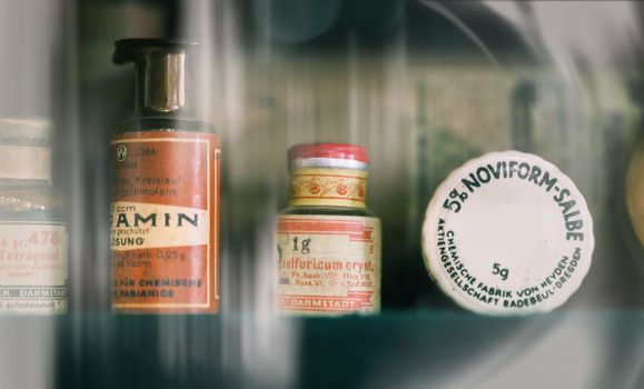 vintage medications in small bottles on a shelf