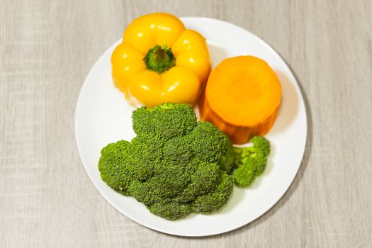 organic broccoli, pepper and pumpkin on a plate