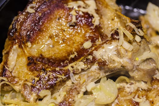 meat with onion close-up in a frying pan