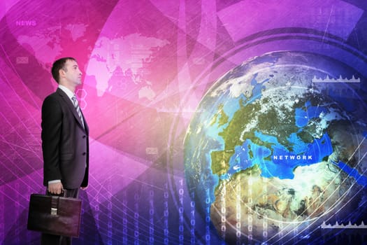 Businessman in front of holographic screen with earth globe. Elements of this image furnished by NASA