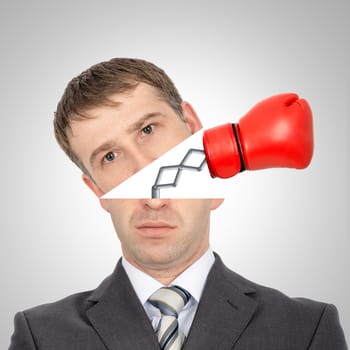 Boxing glove beating from businessmans head on grey background, closeup
