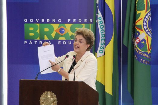 BRAZIL, Brasilia: President Dilma Rousseff holds up a document during a ceremony to appoint former President Luiz Inácio Lula da Silva to the cabinet on March 17, 2016 in Brasilia.The decision resulted in protests throughout the country, with some thinking that the appointment of the former president was an attempt to save him from charges in a corruption scandal.