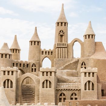 Grand sandcastle on the beach during a summer day