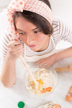 Frustrated Young woman making dough