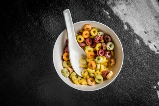 A top view shot of a bowl of colorful cereal.