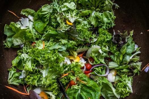 A top view shot of salad with vegetables, carrots and cherry tomatoes.