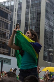 Sao Paulo Brazil March 13, 2016: One unidentified girl taking a selfie in the biggest protest against federal government corruption in Sao Paulo.