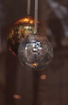 Silver and gold disco balls hang from the ceiling on New Years eve