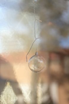 Gold silver Christmas ornament hanging from the ceiling in December