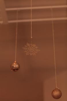 Gold silver Christmas ornament hanging from the ceiling in December