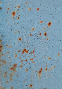 Close-up of peeling paint and rust on a wall