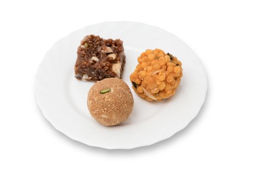 Indian sweets on a plate isolated over white