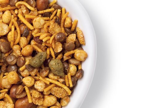 Dry roasted Indian snack mix in a big spoon, isolated