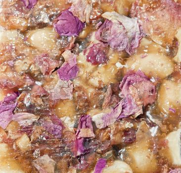Indian sweet brittle with rose petals, close-up