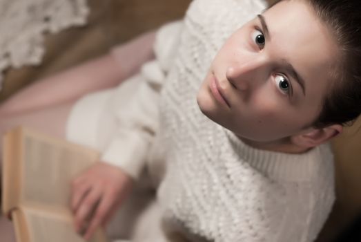 tender portrait of a young girl reading a book 