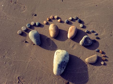 Group of foot by pebble on sand background, amazing concept from stone  with yellow color on beach, awesome art product