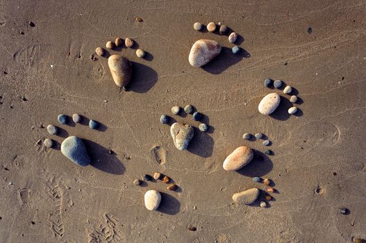 Group of foot by pebble on sand background, amazing concept from stone  with yellow color on beach, awesome art product