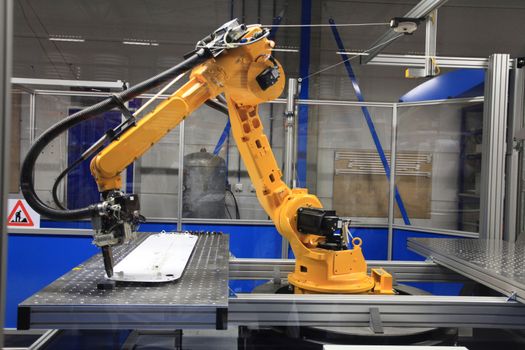 Industrial robotic arm in electronics production line 