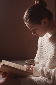 tender portrait of a young girl reading a book 